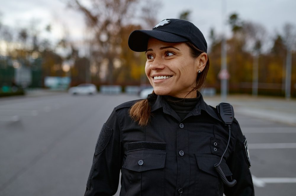 Portrait,Of,Smiling,Police,Woman,On,Street