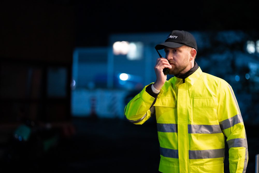 Portrait,Of,Young,Security,Guard,Using,Walkie-talkie,Radio