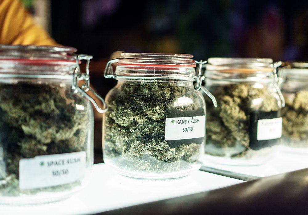 A,Dispensary,Worker,Vending,Jars,Of,Cannabis.