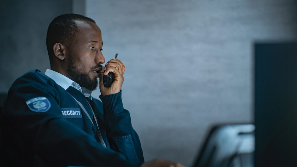 African,American,Security,Officer,Or,Dispatch,In,Uniform,Uses,Tablet