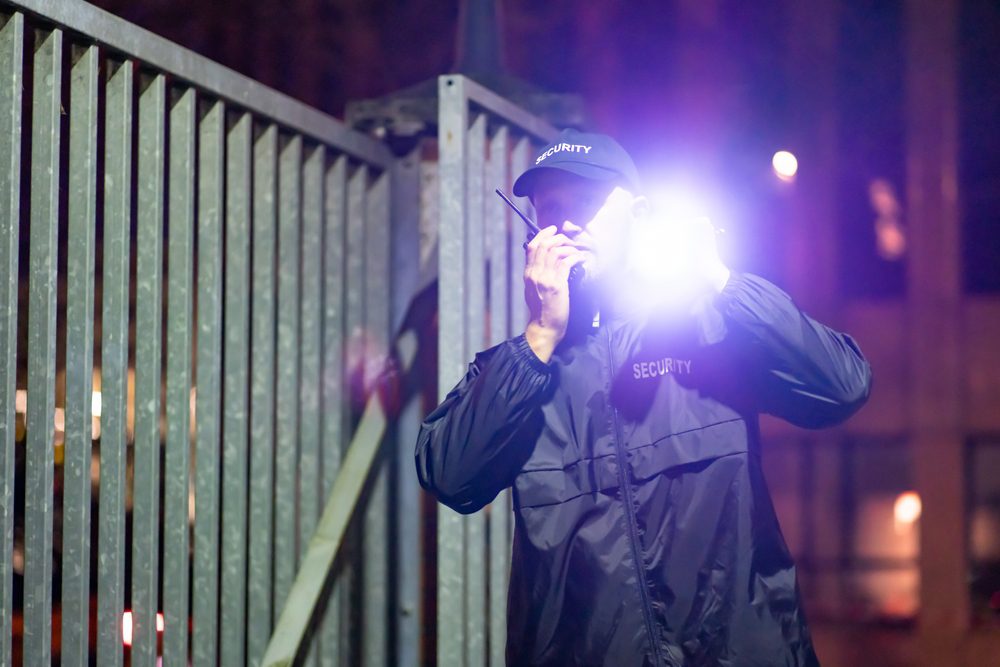 Security,Guard,At,Entrance,Gate,At,Night