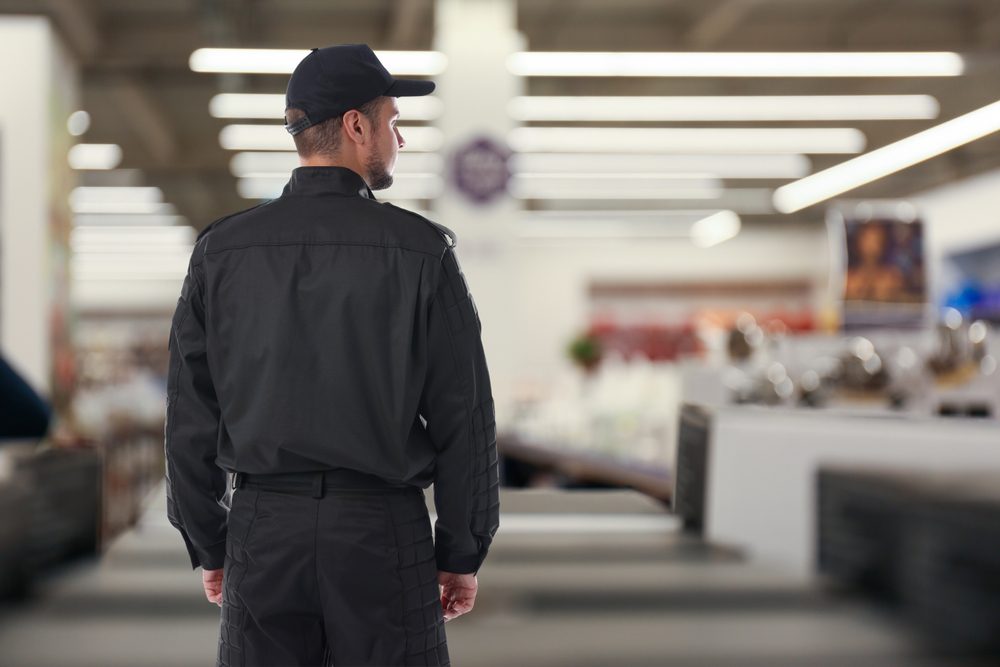 Security,Guard,In,Supermarket,,Back,View.,Space,For,Text