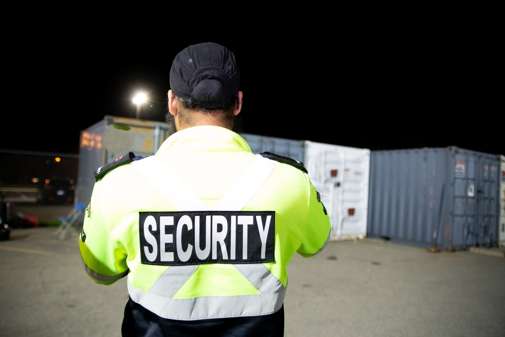 A,security,guard,is,patrolling,a,commercial,storage,area,at