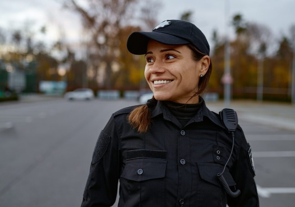 Portrait,Of,Smiling,Police,Woman,On,Street