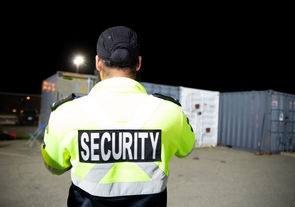 A,Security,Guard,Is,Patrolling,A,Commercial,Storage,Area,At