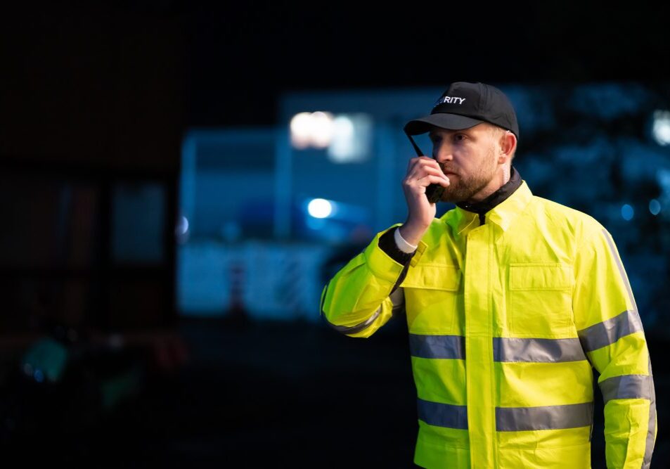 Portrait,Of,Young,Security,Guard,Using,Walkie-talkie,Radio