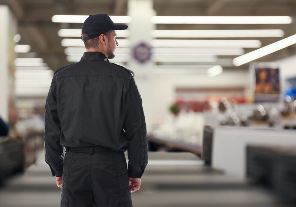 Security,Guard,In,Supermarket,,Back,View.,Space,For,Text