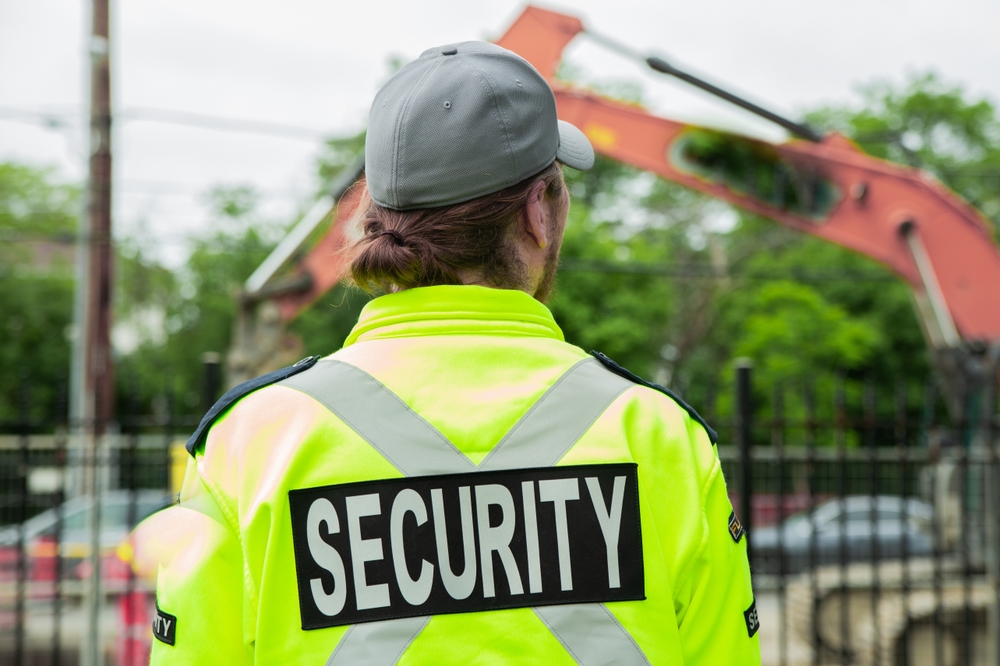 Security,guard,watching,construction,site,on,the,street