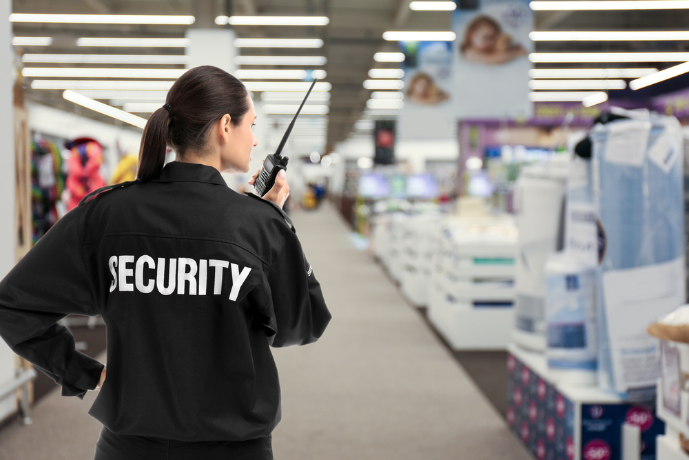 Security,guard,using,portable,radio,transmitter,in,shopping,mall,,space